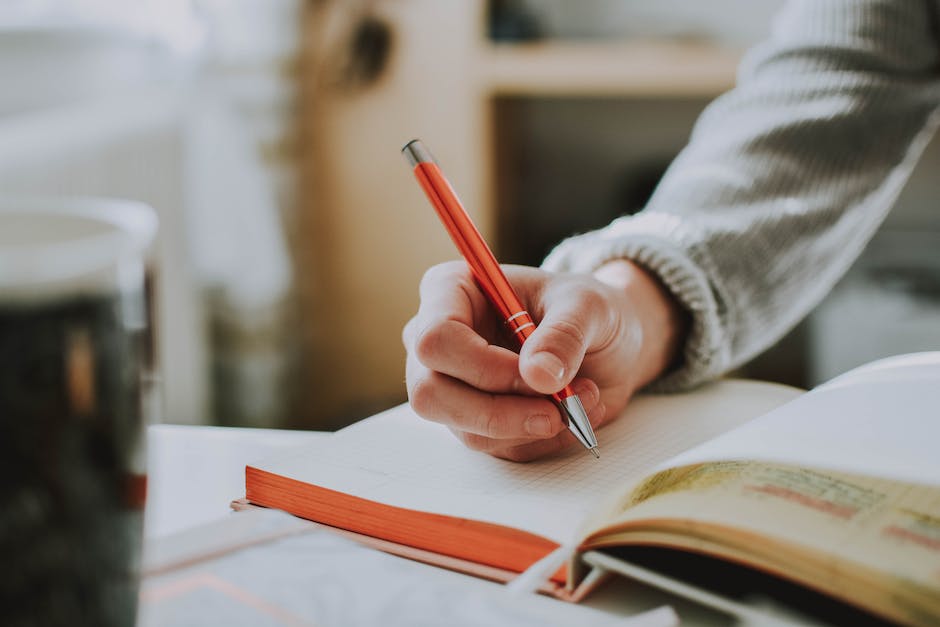 Image of a person holding an autographed book in their hands