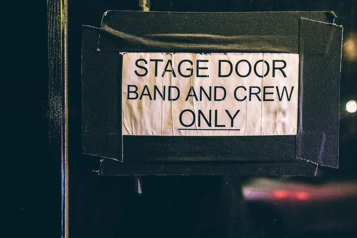 Image of fans waiting at a stage door after a theater performance